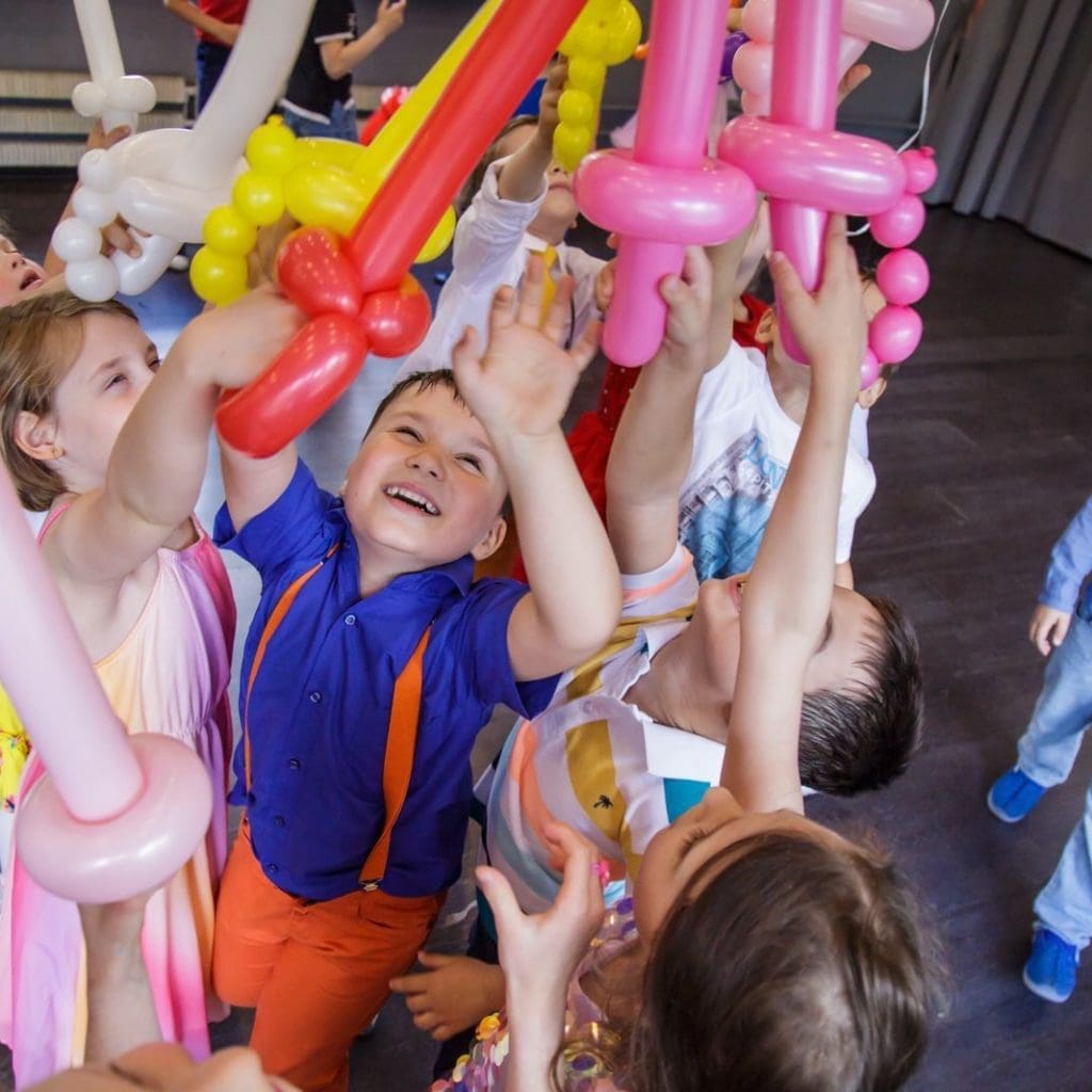 Merry kids playing with balloons