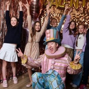 Clown entertainer with happy children at party in Vienna